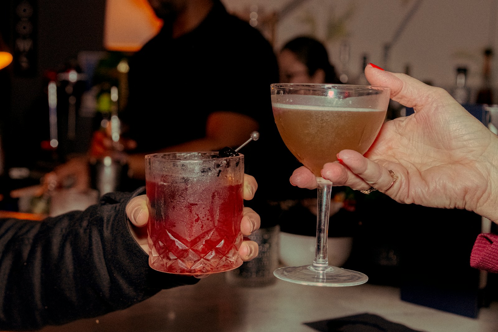 Friends sharing cocktails in the evening